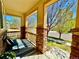 Charming front porch with stone pillars, a striped rug, and a view of the neighborhood at 10995 Quintero St, Commerce City, CO 80022