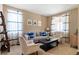 Bright living room with comfortable seating, neutral walls, and stylish curtains, creating a cozy atmosphere at 10995 Quintero St, Commerce City, CO 80022