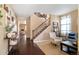 Inviting living room with hardwood floors, staircase, and a comfortable seating area, perfect for relaxation and gatherings at 10995 Quintero St, Commerce City, CO 80022