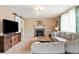 Comfortable living room featuring a stone fireplace, stylish decor, and a sliding barn door at 10995 Quintero St, Commerce City, CO 80022
