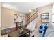 Inviting living room featuring rich hardwood floors, an accent wall, and a staircase to the upper level at 10995 Quintero St, Commerce City, CO 80022