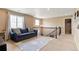 Comfortable loft area with stylish seating, large windows, and neutral decor at 10995 Quintero St, Commerce City, CO 80022