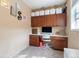 Organized home office with built-in cabinets, a functional workspace, and ample storage at 10995 Quintero St, Commerce City, CO 80022