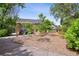 Landscaped backyard with a pergola-covered seating area and lush greenery, ideal for outdoor relaxation at 1456 Syracuse St, Denver, CO 80220