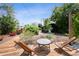 Serene backyard deck setting with wooden chairs and a small table, offering a relaxing outdoor retreat at 1456 Syracuse St, Denver, CO 80220