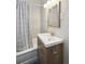 Tastefully updated bathroom with a modern vanity, new fixtures, and shower with tub at 1456 Syracuse St, Denver, CO 80220