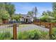 Landscaped front yard with gravel and a charming fence enhances the home's appeal at 1456 Syracuse St, Denver, CO 80220