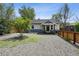 Charming home with gravel yard, nice landscaping, and a fence, creating curb appeal at 1456 Syracuse St, Denver, CO 80220