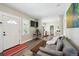 Open-concept living room with modern decor, stylish seating and a view into the kitchen at 1456 Syracuse St, Denver, CO 80220
