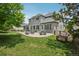 Large backyard with a patio, outdoor seating, and a well-manicured lawn at 6553 S Sedalia St, Aurora, CO 80016