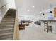 Finished basement with open floorplan, carpet floors, a bar, and stairs at 6553 S Sedalia St, Aurora, CO 80016