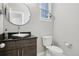 Powder room with a stylish vessel sink, a sleek dark wood vanity, and modern finishes at 6553 S Sedalia St, Aurora, CO 80016