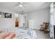 Comfortable bedroom with hardwood floors, rocking chair, and ensuite bathroom at 6553 S Sedalia St, Aurora, CO 80016