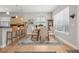 Elegant dining room with hardwood floors and view of the kitchen area, illuminated by modern lighting at 6553 S Sedalia St, Aurora, CO 80016