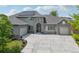 Stunning stone-accented home with a well-manicured lawn, solar panels, and a spacious concrete driveway at 6553 S Sedalia St, Aurora, CO 80016