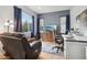 Comfortable home office with a large window, a desk, and a leather recliner at 6553 S Sedalia St, Aurora, CO 80016
