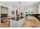 Spacious kitchen with stainless steel appliances, dark countertops, and a center island with seating at 6553 S Sedalia St, Aurora, CO 80016