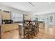Well-lit kitchen featuring stainless steel appliances, light-colored cabinetry and a granite island with seating at 6553 S Sedalia St, Aurora, CO 80016