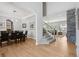 Open-concept floor plan with hardwood floors, leading to a dining area and a cozy living space at 6553 S Sedalia St, Aurora, CO 80016