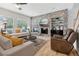 Comfortable living room with a stone accent wall, built-in shelves, and lots of natural light at 6553 S Sedalia St, Aurora, CO 80016