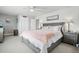 Spacious bedroom with a large bed, side tables, and views to multiple interior doors at 6553 S Sedalia St, Aurora, CO 80016
