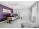 Office with purple accent wall, fan, desk with multiple monitors and open floorplan at 6553 S Sedalia St, Aurora, CO 80016