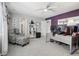 Office with purple accent wall, fan, desk with multiple monitors and chair at 6553 S Sedalia St, Aurora, CO 80016
