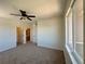 Cozy bedroom with large window, ceiling fan, neutral carpet, and access to the ensuite bathroom at 8481 W Union Ave # 2-204, Littleton, CO 80123