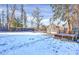 Expansive backyard covered in snow, featuring a charming greenhouse, and mature trees at 5725 W Mississippi Ave, Lakewood, CO 80226