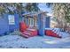 Cozy backyard patio with red stairs and pergola, perfect for outdoor entertaining in a charming setting at 5725 W Mississippi Ave, Lakewood, CO 80226