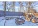 Backyard patio area with built in BBQ, perfect for outdoor entertaining in a winter landscape at 5725 W Mississippi Ave, Lakewood, CO 80226