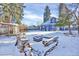 Spacious backyard featuring a greenhouse, patio area, mature trees, and a fire pit at 5725 W Mississippi Ave, Lakewood, CO 80226