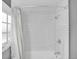 Bathroom featuring white subway tile and a shower with a chrome showerhead at 5725 W Mississippi Ave, Lakewood, CO 80226