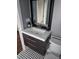 Modern bathroom with sleek vanity, black framed mirror, and stylish black and white patterned flooring at 5725 W Mississippi Ave, Lakewood, CO 80226