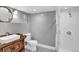 Updated bathroom featuring a modern vanity, tiled shower, and elegant mirror at 5725 W Mississippi Ave, Lakewood, CO 80226
