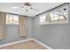 Cozy bedroom with neutral carpet, two windows, and a ceiling fan at 5725 W Mississippi Ave, Lakewood, CO 80226