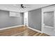 Bedroom with hardwood floors, a closet, and an ensuite bathroom with black and white tiles at 5725 W Mississippi Ave, Lakewood, CO 80226