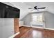 Bedroom with hardwood floors, a ceiling fan, and a brick wall accent at 5725 W Mississippi Ave, Lakewood, CO 80226