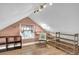 Bonus room features wood floors, unique lighting, and sloped ceilings at 5725 W Mississippi Ave, Lakewood, CO 80226
