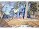 Charming blue home with red-painted porch steps and mature trees at 5725 W Mississippi Ave, Lakewood, CO 80226