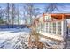 Charming greenhouse with ample natural light, set in a snowy backyard landscape at 5725 W Mississippi Ave, Lakewood, CO 80226