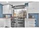 Updated kitchen with stainless steel range, oven, and hood with lots of natural light at 5725 W Mississippi Ave, Lakewood, CO 80226