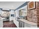 Renovated kitchen featuring stainless steel appliances and farmhouse sink with large windows at 5725 W Mississippi Ave, Lakewood, CO 80226