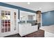 Bright kitchen features stainless steel appliances and a farmhouse sink with lots of natural light at 5725 W Mississippi Ave, Lakewood, CO 80226