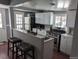 Modern kitchen featuring white cabinets, stainless steel appliances, and breakfast bar with seating at 5725 W Mississippi Ave, Lakewood, CO 80226