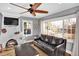 Inviting living room featuring a fireplace, hardwood floors, and large windows at 5725 W Mississippi Ave, Lakewood, CO 80226