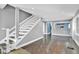 View of the home's staircase and hardwood floors from the living room area at 5725 W Mississippi Ave, Lakewood, CO 80226