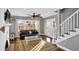 Inviting living room featuring a unique fireplace, hardwood floors, and staircase at 5725 W Mississippi Ave, Lakewood, CO 80226