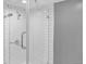 Close-up of a tiled shower with glass door and chrome fixtures at 5725 W Mississippi Ave, Lakewood, CO 80226
