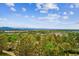 Scenic aerial view showcasing a community surrounded by lush greenery and distant mountain vistas at 487 Interlocken Blvd # 104, Broomfield, CO 80021